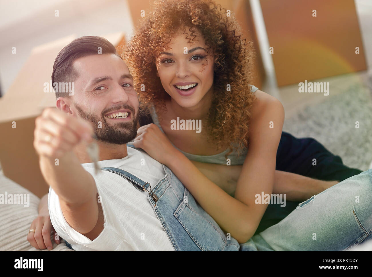 young couple holding the key to a new apartment Stock Photo - Alamy