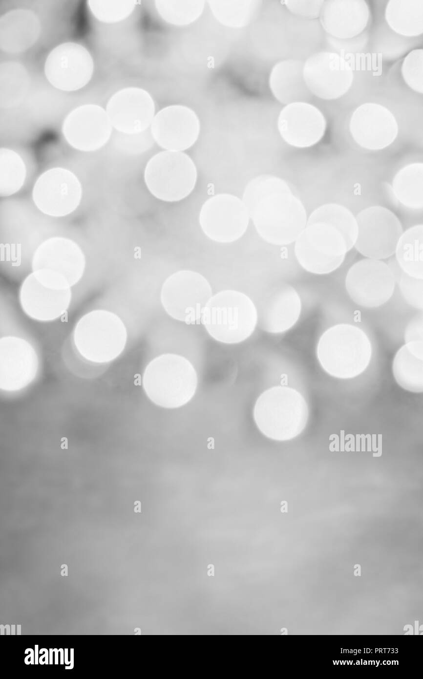 Abstract background of metallic black and white holiday bokeh lights with free space for text. Stock Photo