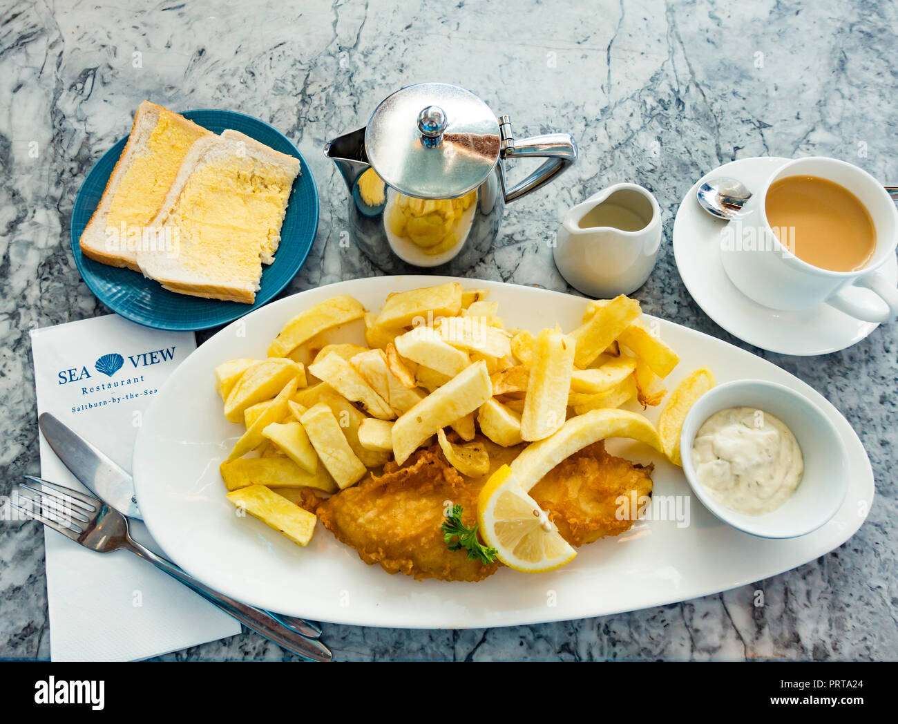 Over 65's Special Fish & Chips a small Cod with white bread and butter cup of tea and tartare sauce at Seaview Restaurant Saltburn Yorkshire England Stock Photo