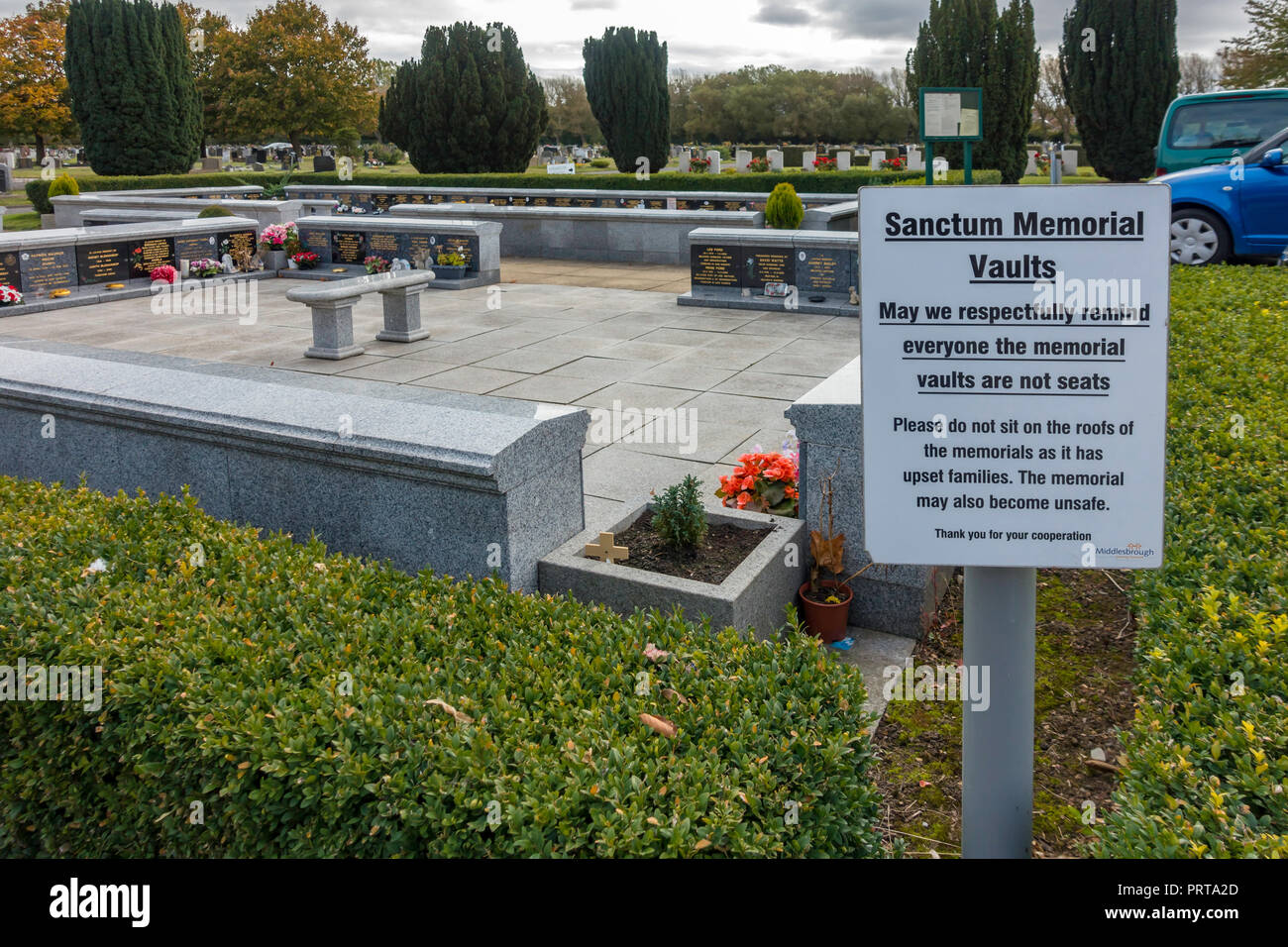 Sanctum Memorial Vaults in the garden of Remembrance in Acklam cemetery Middlesborough with a notice requesting people not to sit on them Stock Photo