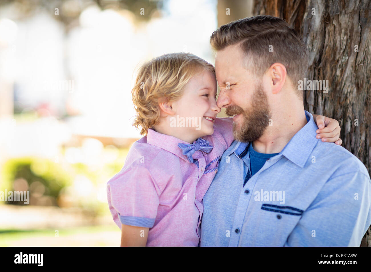 Young Caucasian Father And Son Portrait At The Park. Stock Photo