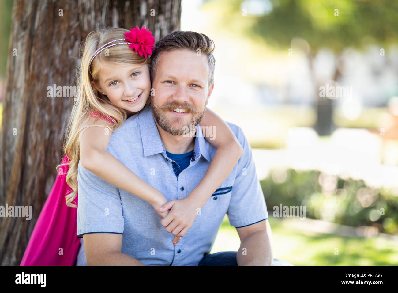 Young Caucasian Father And Daughter Portrait At The Park. Stock Photo