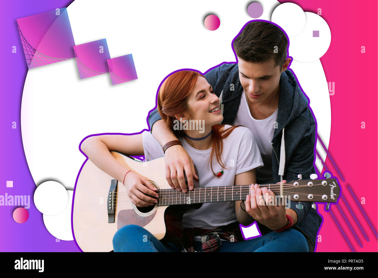 Young girl taking guitar lessons and feeling interested Stock Photo