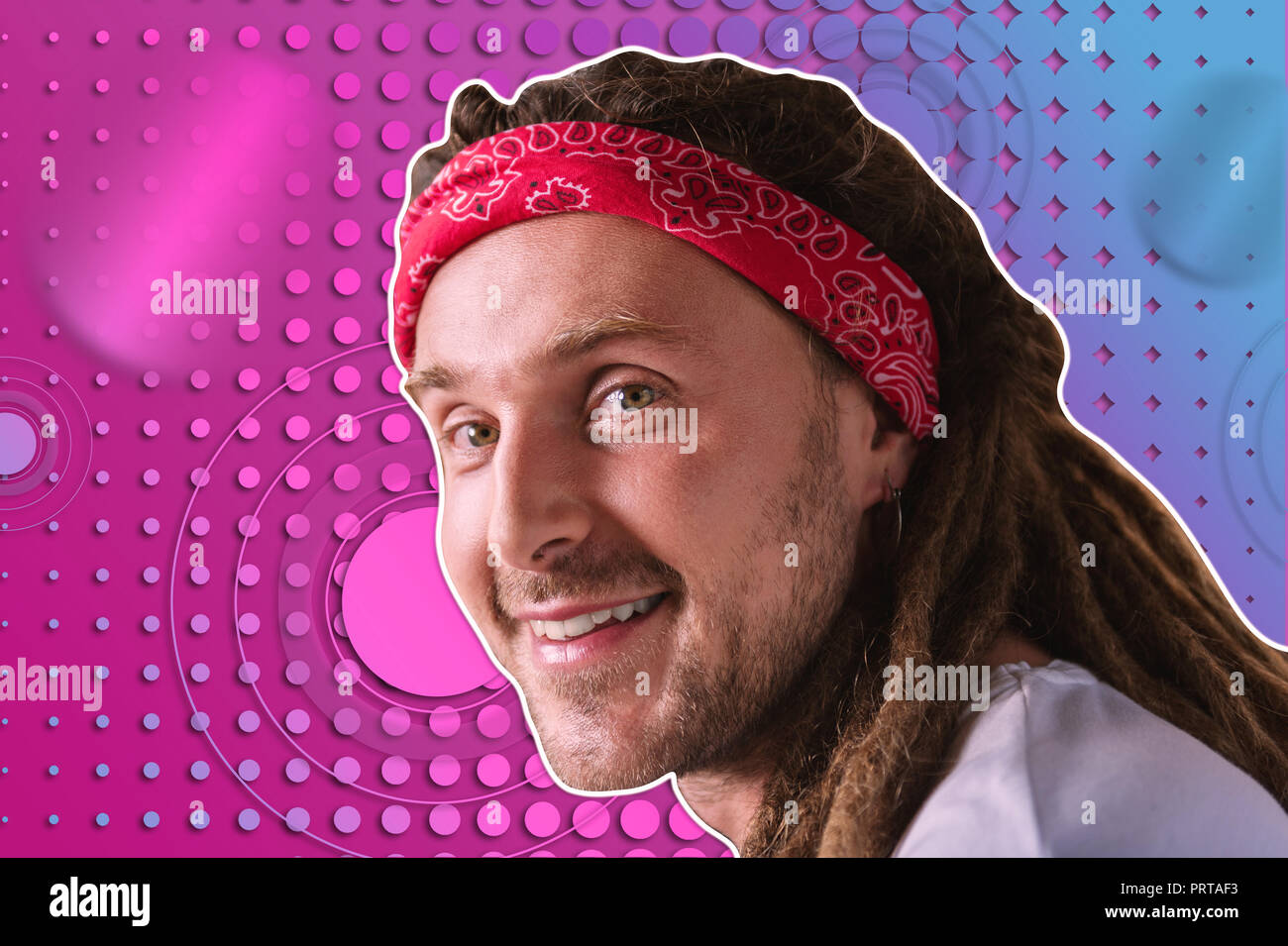 Unusual pleasant man with dreadlocks posing on the bright background Stock Photo
