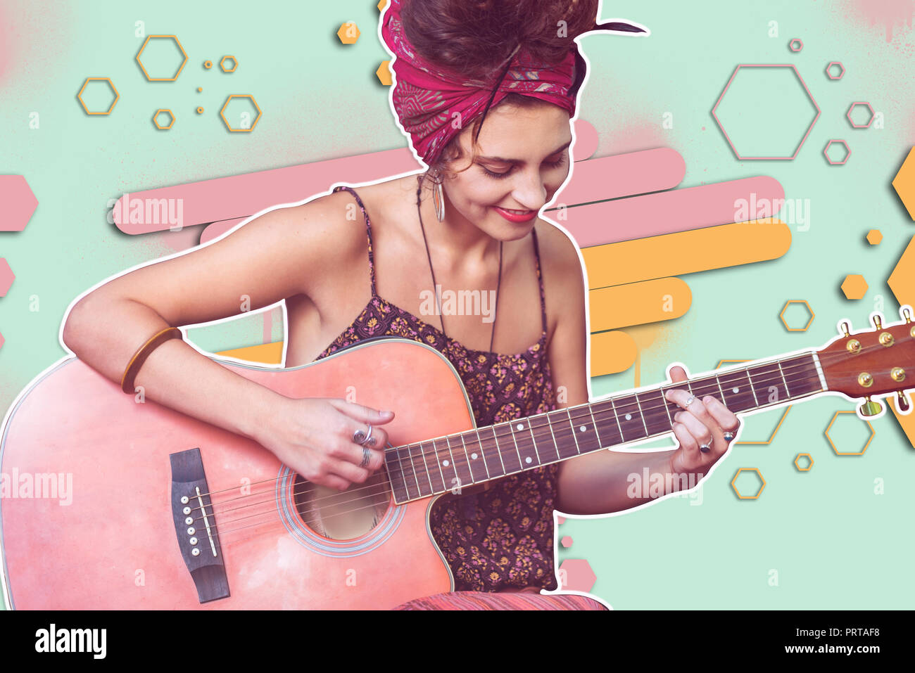 Wonderful talanted young lady playing a guitar Stock Photo