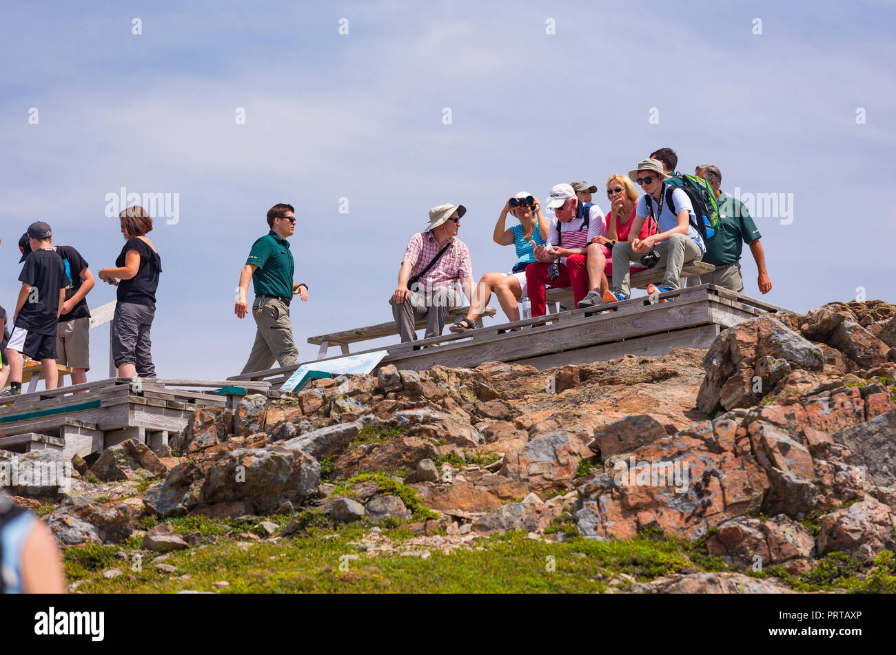 CAPE BRETON, NOVA SCOTIA, CANADA - Hikers on bench on Skyline Trail in Cape Breton Highlands National Park. Stock Photo