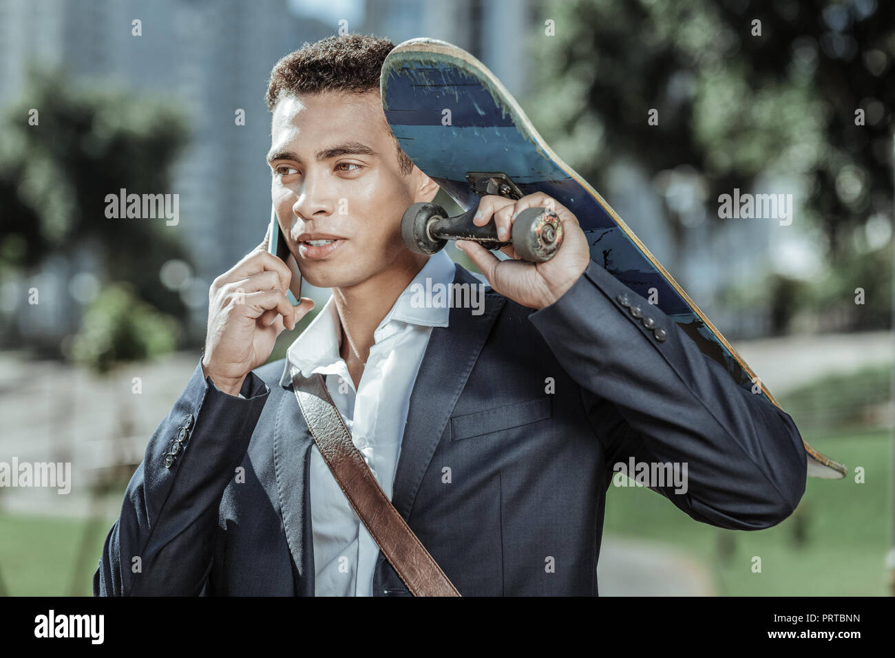 Glad male student returning after his classes Stock Photo