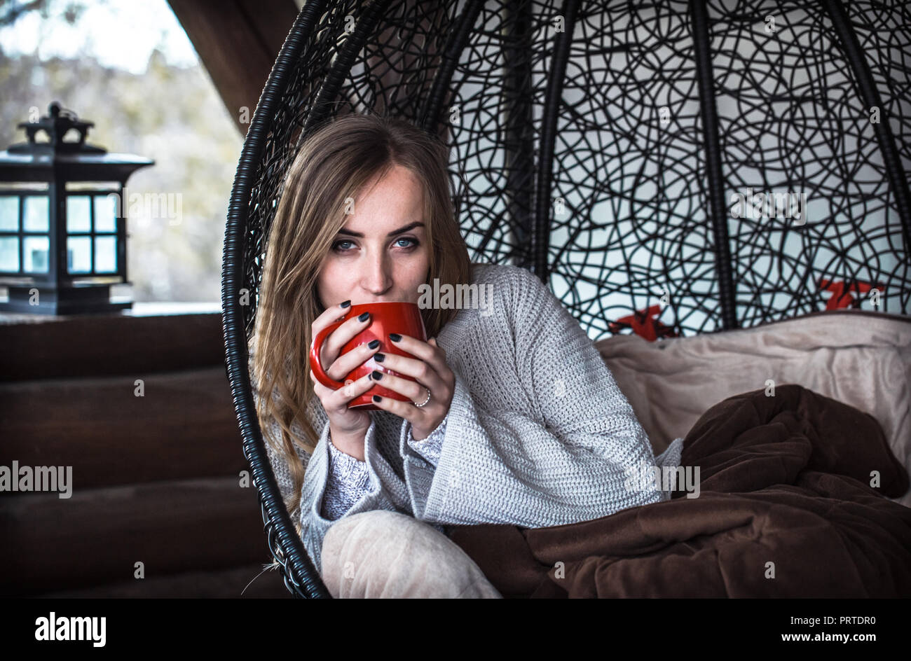 Beautiful girl with Cup of tea sitting in a comfortable chair Stock ...