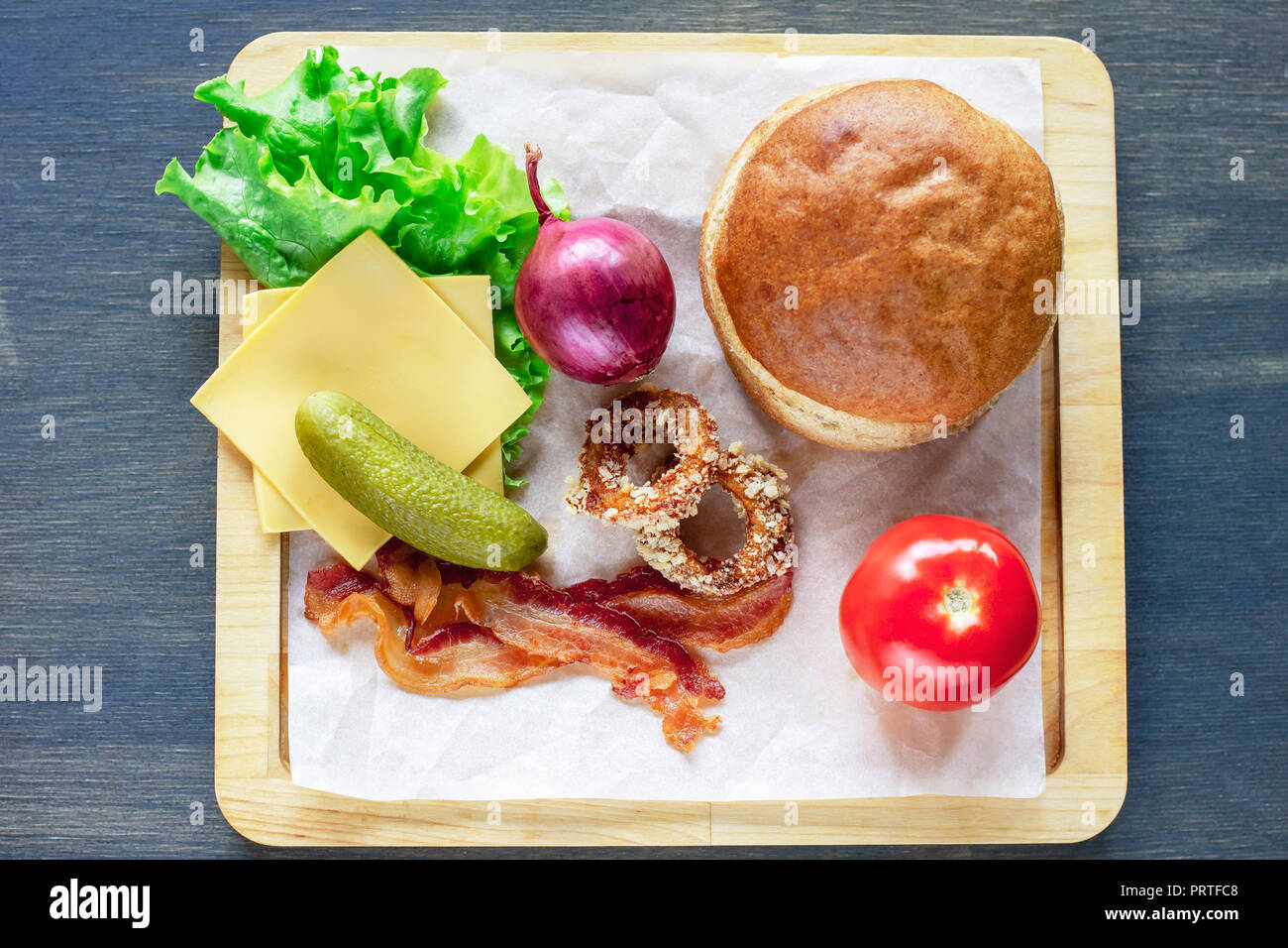 Ingredients for Burger bun, onion, lettuce, tomato, bacon and ot Stock