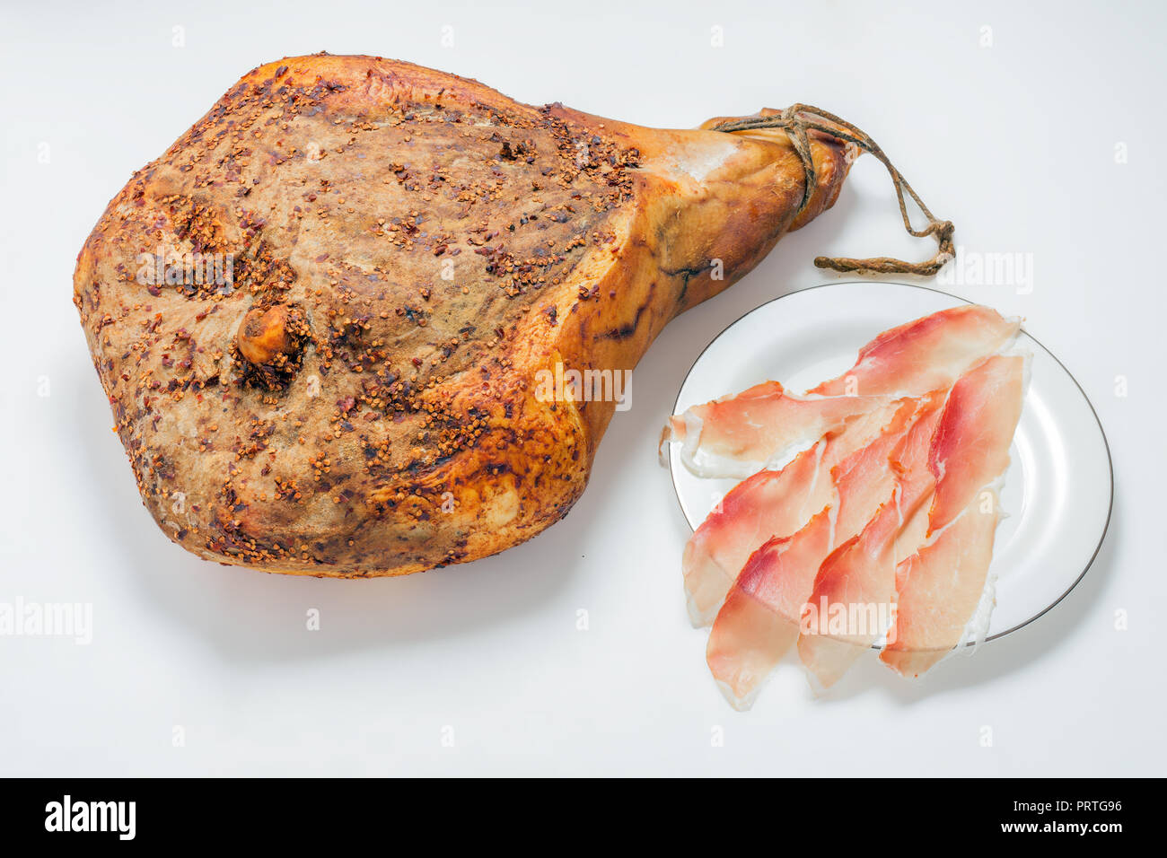 taste of organic prosciutto ham on white background Stock Photo
