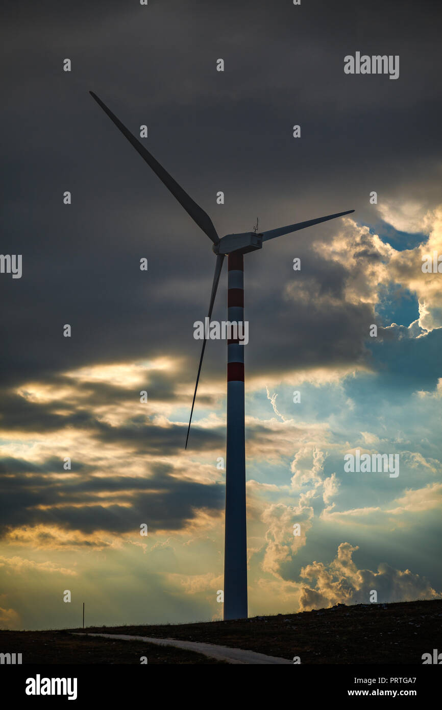 wind turbine with a cloudy sunset, Abruzzo Stock Photo