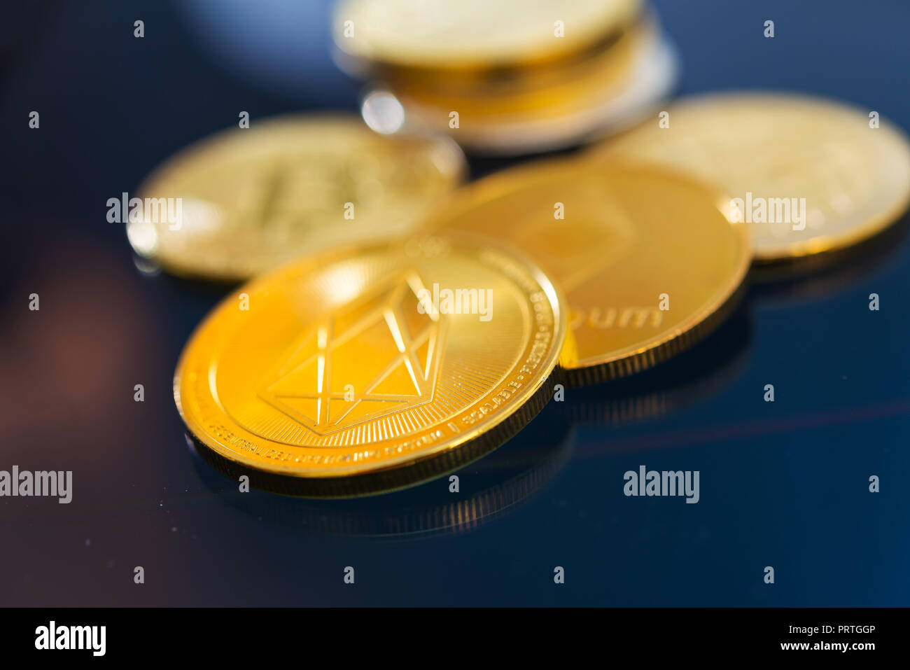 Golden EOS.IO and mound of money. Digital cryptocurrency concept Stock Photo