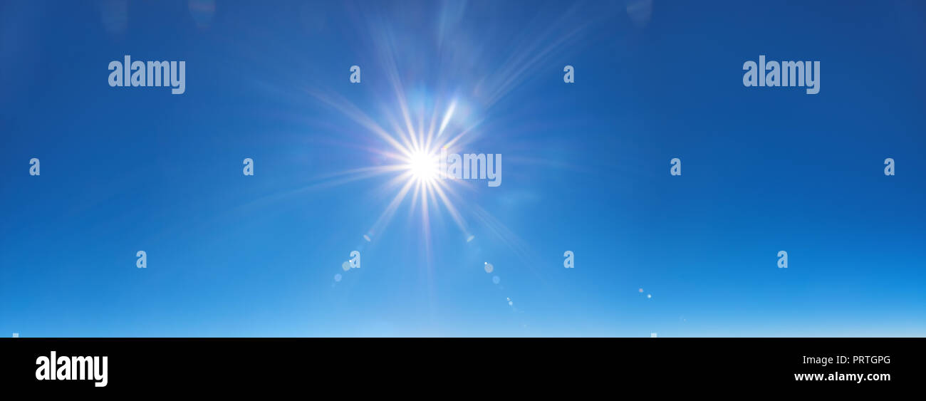 sky background with sun beams on bright blue sky Stock Photo