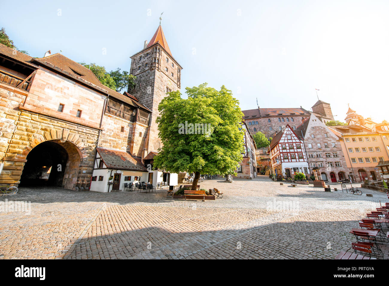 Morning street view with castle wall and halftimbered houses in