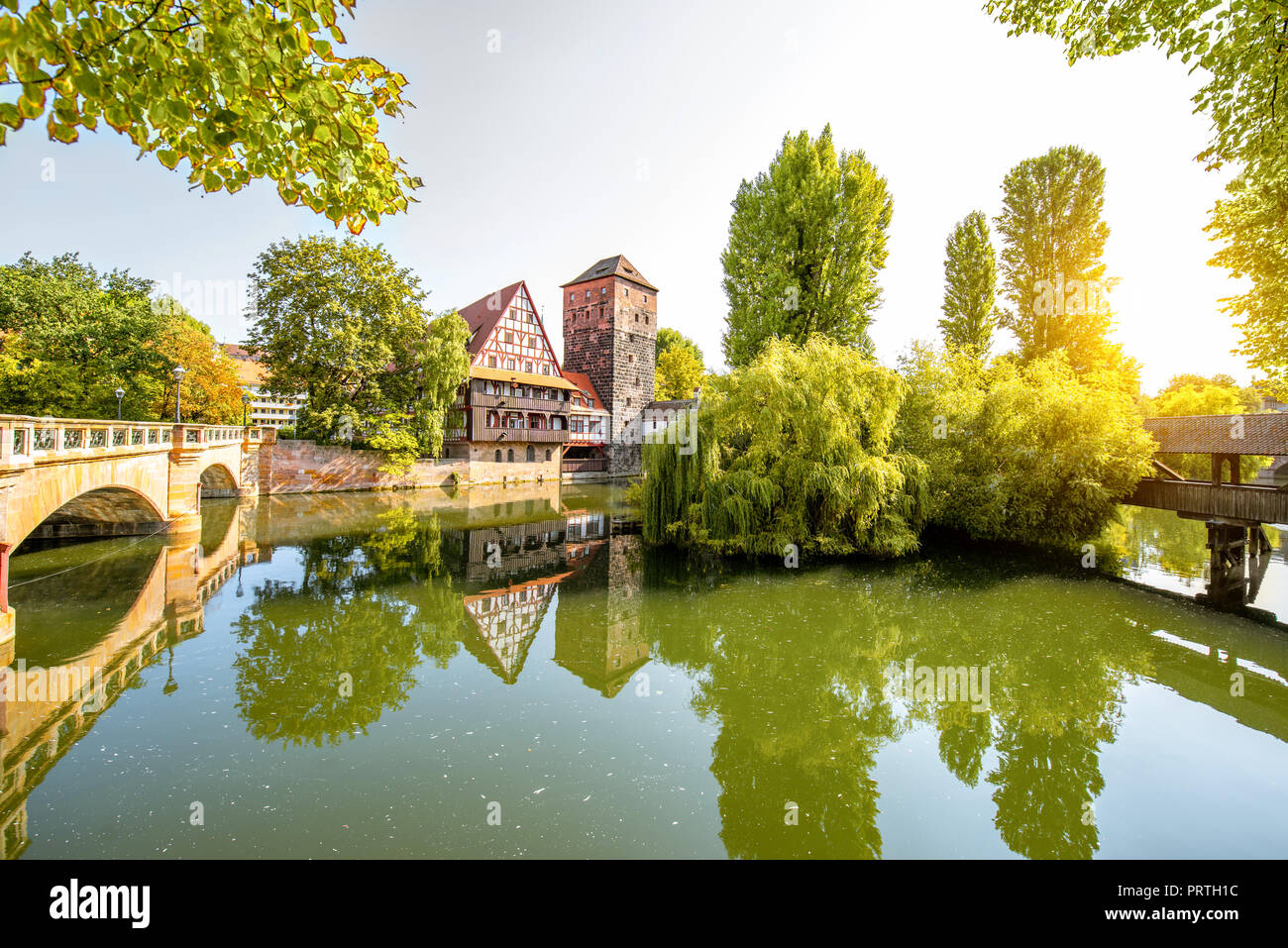 Beautiful landscape view on the riverside with old tower, house in Nurnberg during the sunrise, Germany Stock Photo