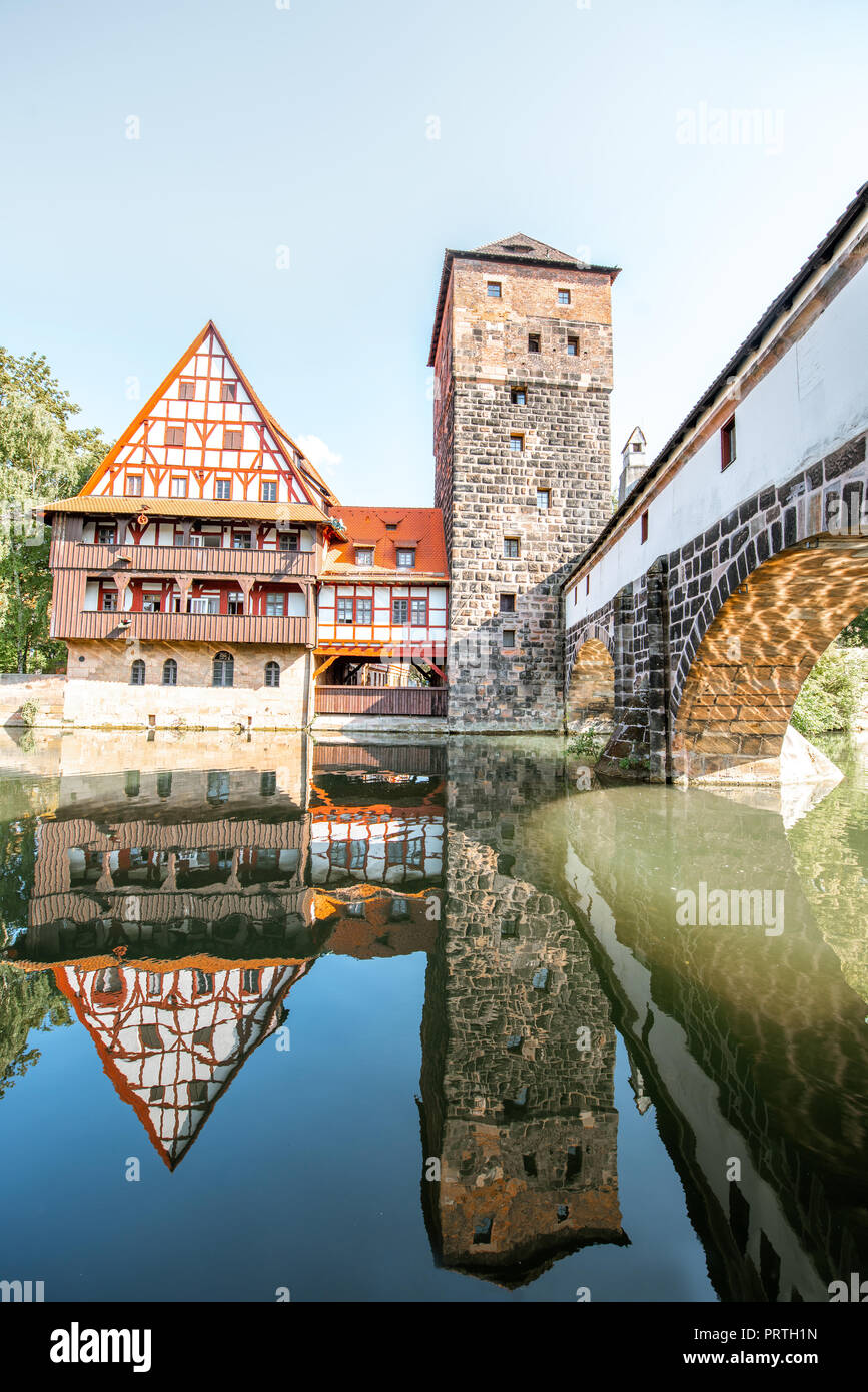 Beautiful landscape view on the riverside with old tower and house with reflection in Nurnberg during the sunrise, Germany Stock Photo