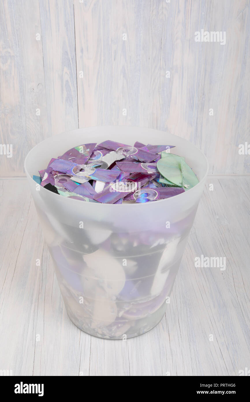 trash with stripes of shredded CD and DVD data disc destroyed by ...