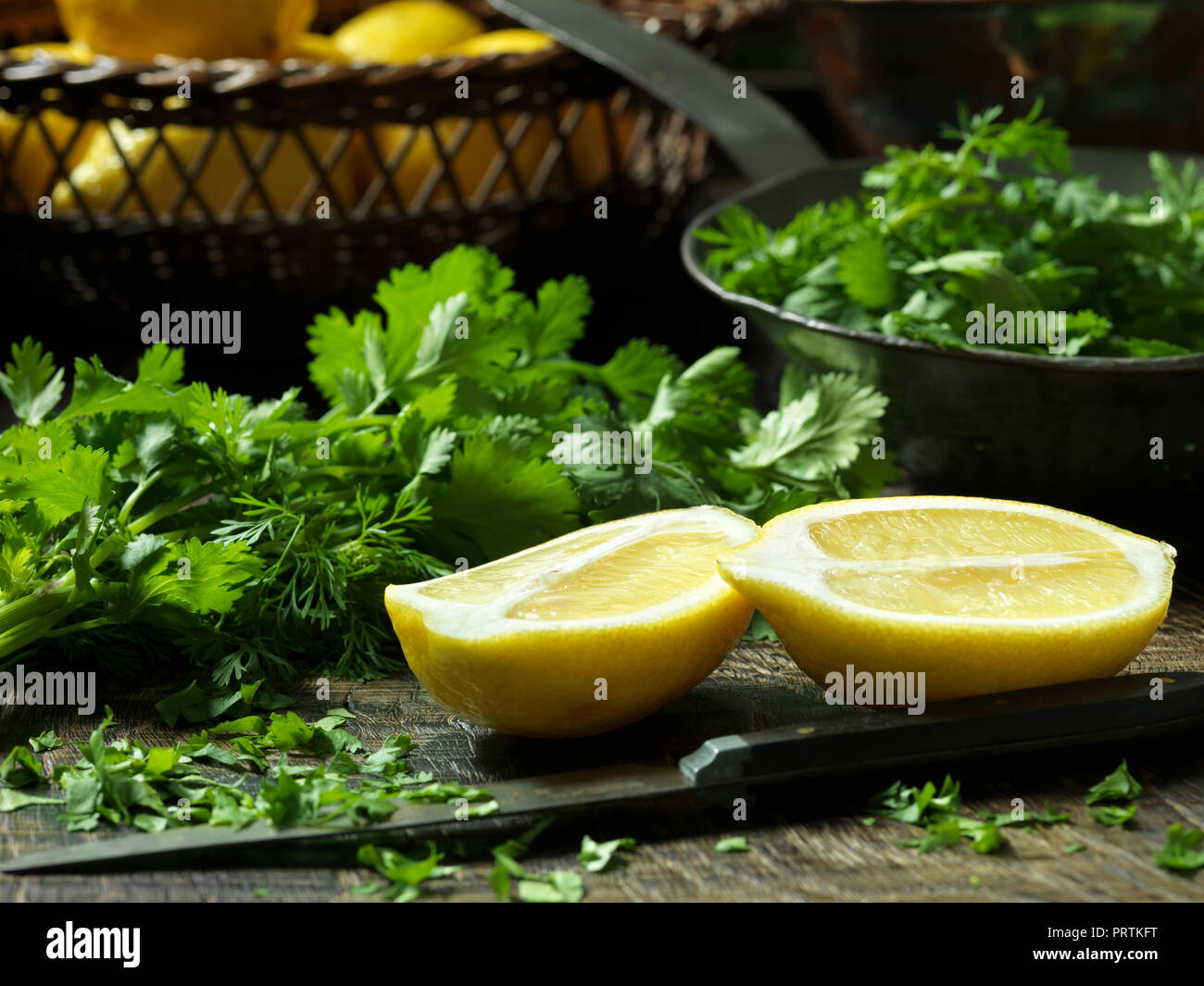 Lemon halves and chopped Parsley Stock Photo