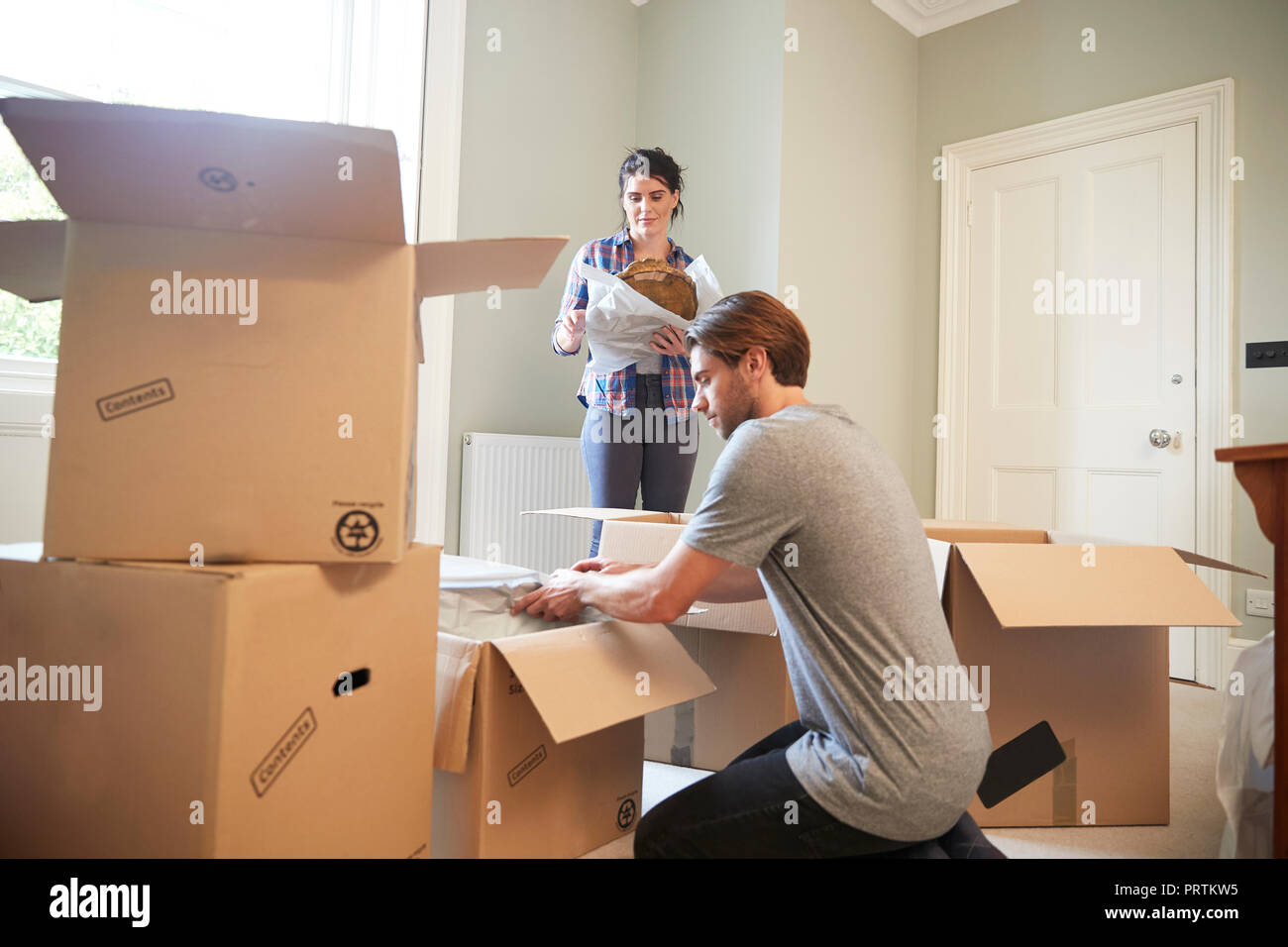 Couple packing belongings in cardboard boxes Stock Photo