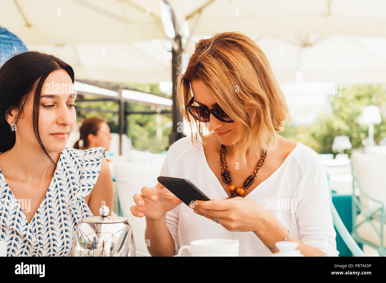 Women having tea on terrace Stock Photo