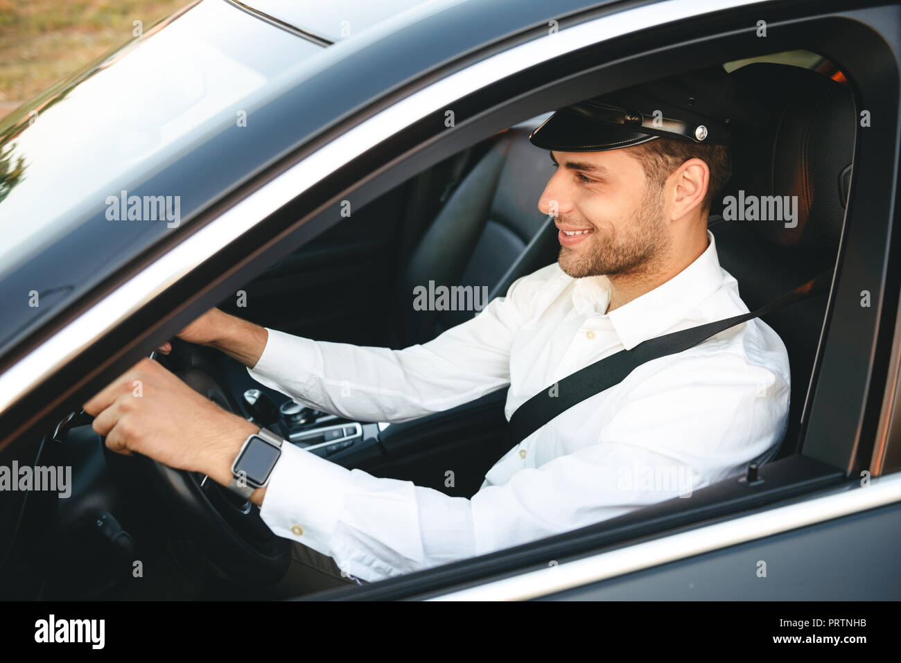 Portrait of happy european man taxi driver wearing uniform and cap