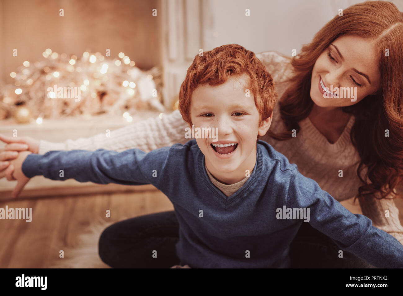 Close up of amused child sitting with his mother Stock Photo