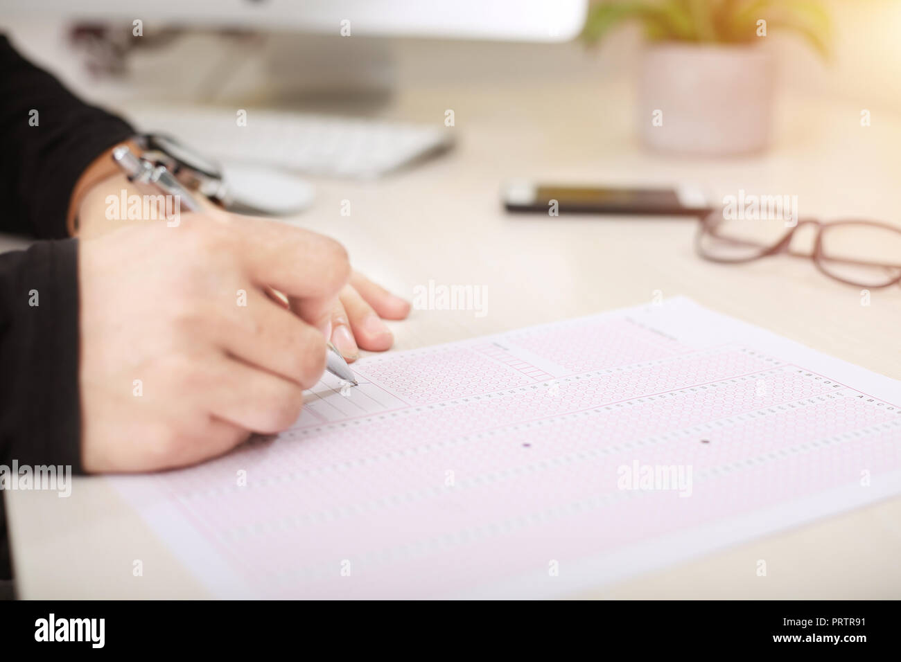 Man is filling exam omr sheet with pen Stock Photo Alamy