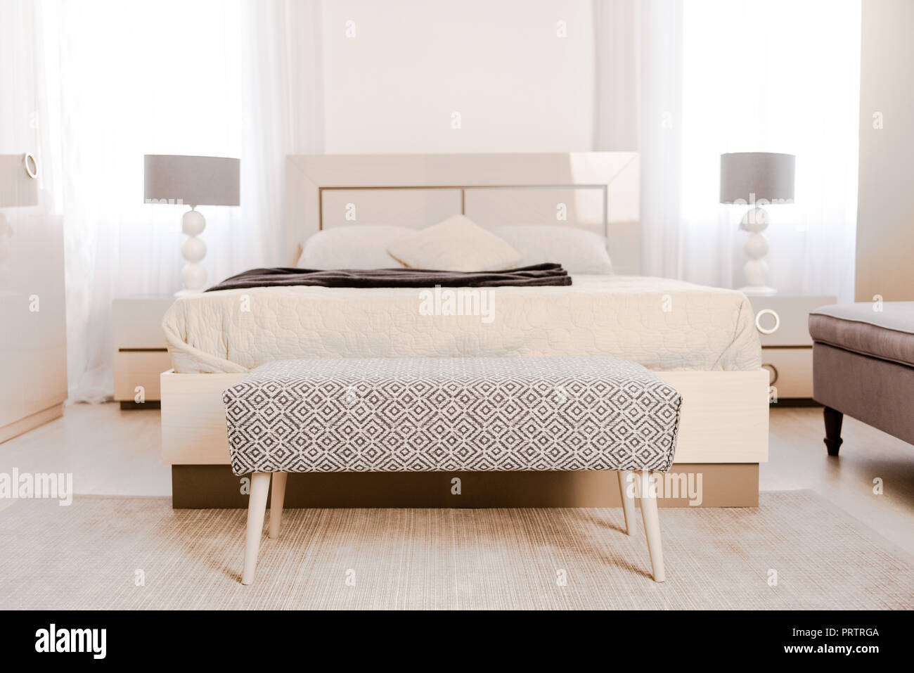 interior of modern light bedroom with soft bed and lamps Stock Photo