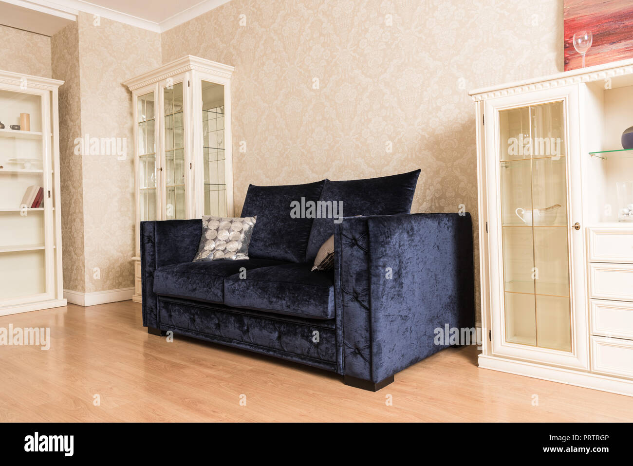 interior of living room with blue sofa, wooden shelves and floor Stock Photo