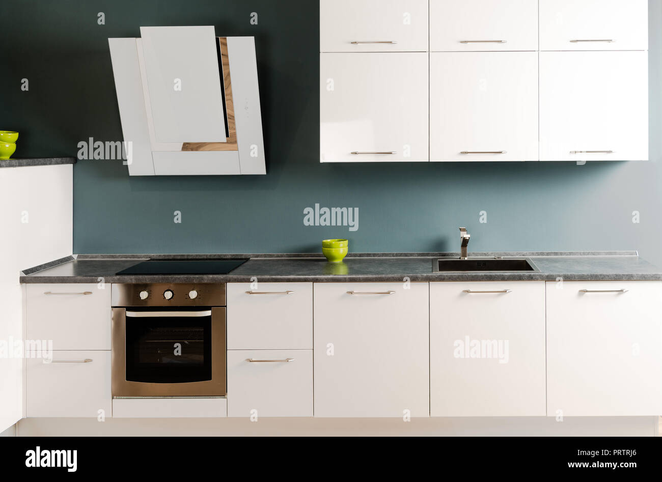 interior of modern kitchen with white kitchen counter, stove and oven ...