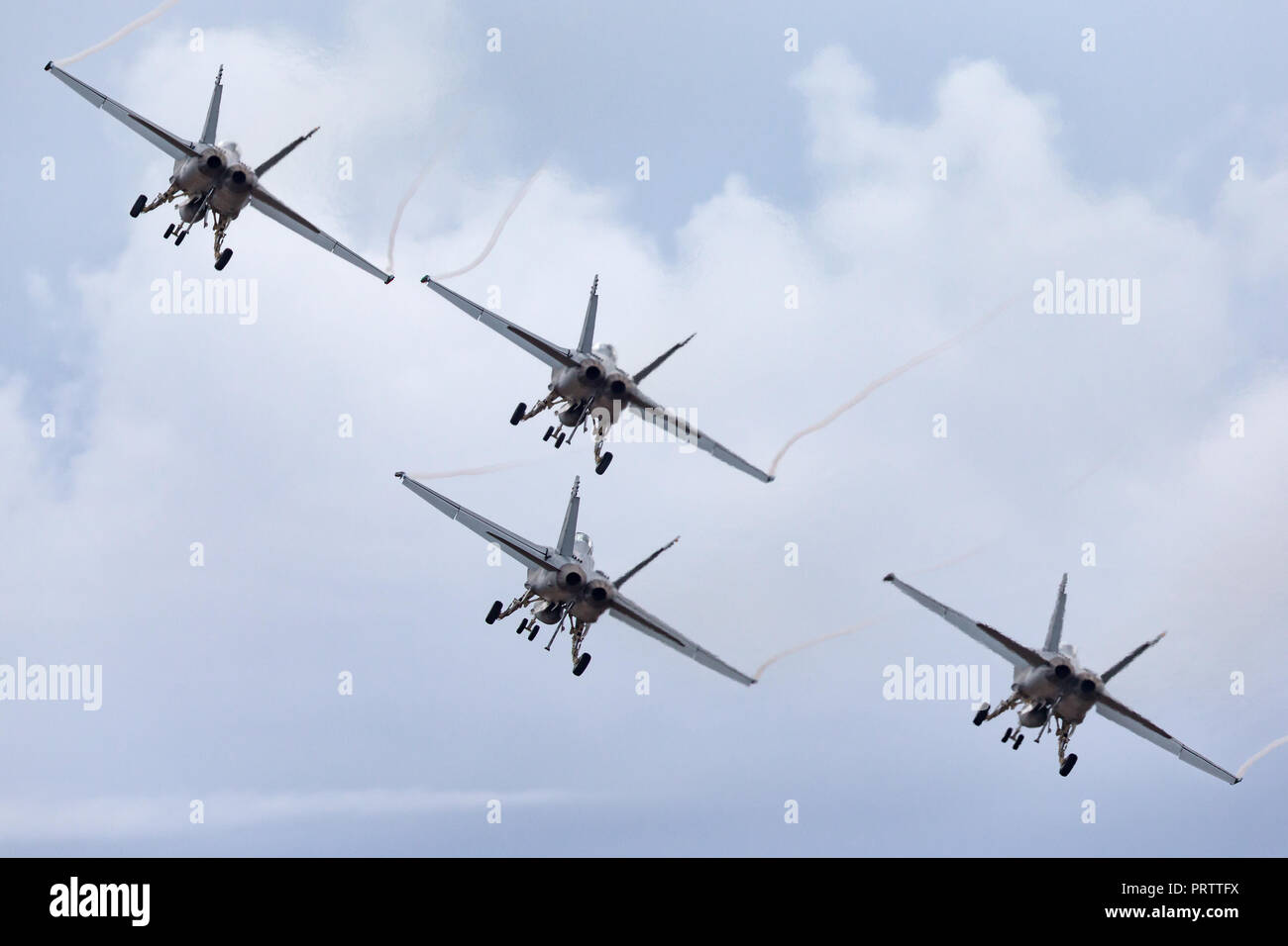 Four Royal Australian Air Force (RAAF) Boeing F/A-18F Super Hornet multirole fighter aircraft flying in formation. Stock Photo