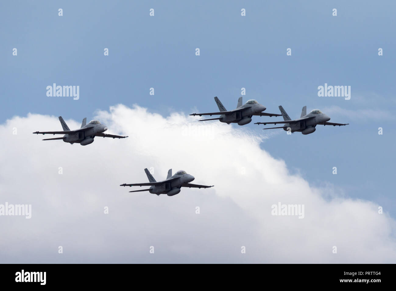 Four Royal Australian Air Force (RAAF) Boeing F/A-18F Super Hornet multirole fighter aircraft flying in formation. Stock Photo