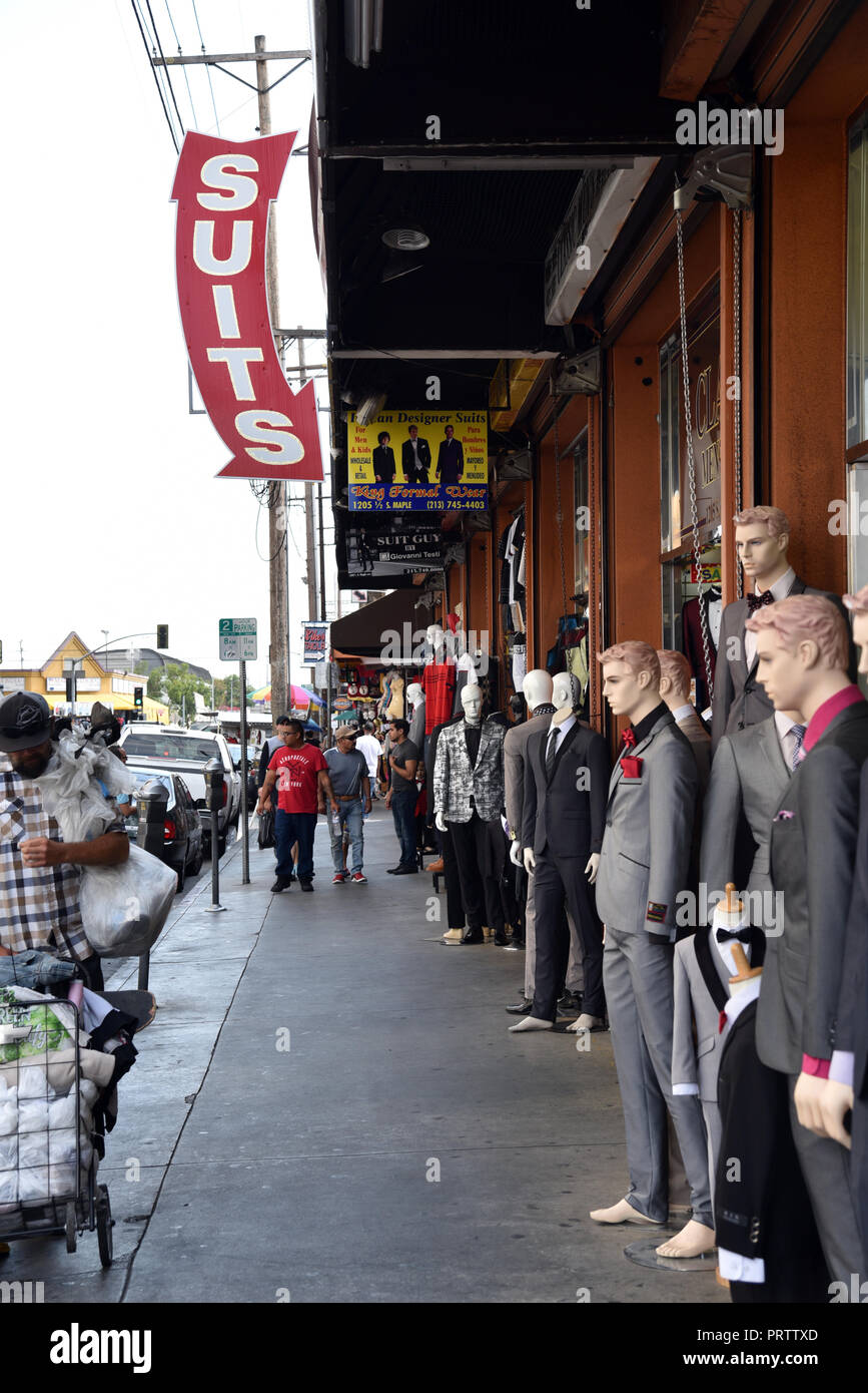 Shoppers, vendors and clothing mannequins line the sidewalk in the Los