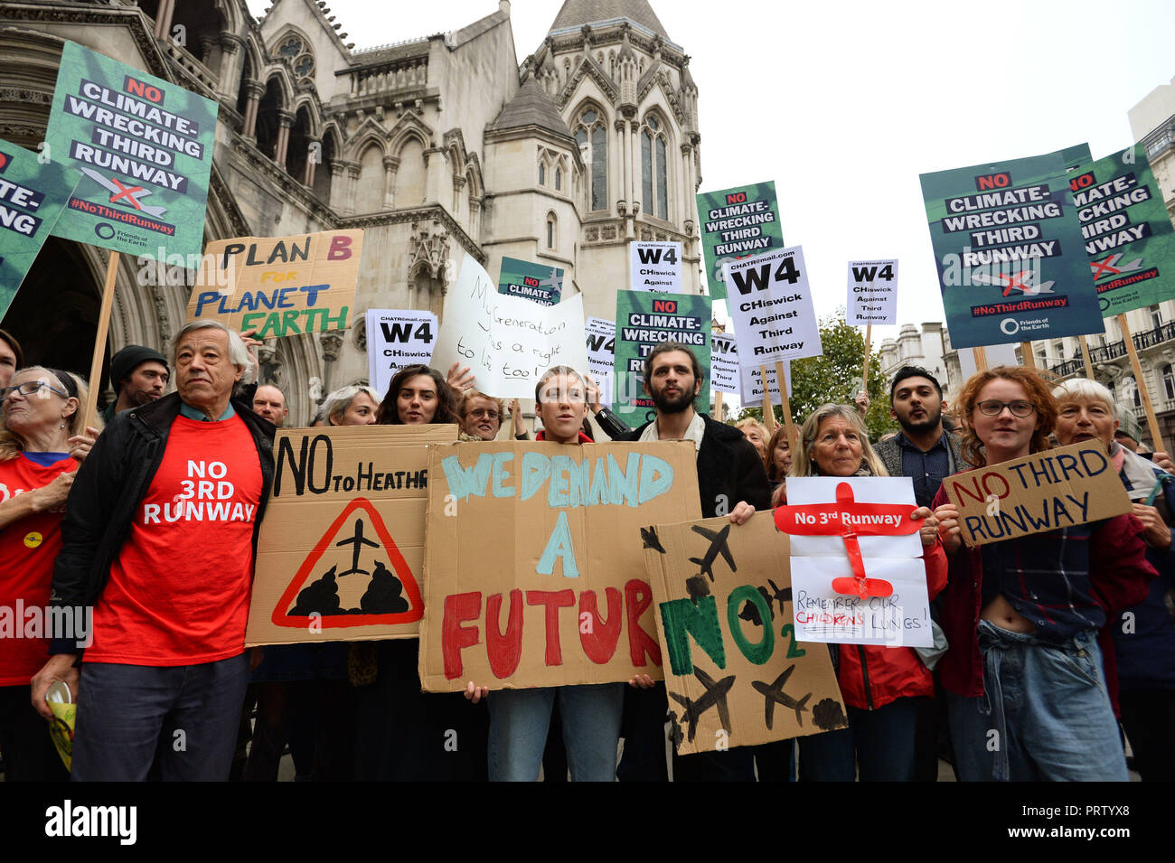 Protestors gather outside the Royal Courts of Justice, as legal action over plans to expand Heathrow is launched. Stock Photo