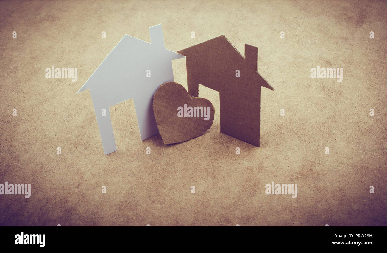 Heart shaped icon and paper houses on a brown background Stock Photo ...