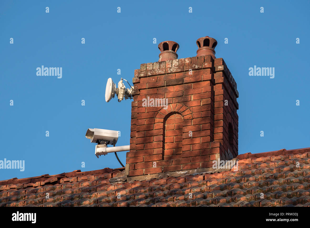 A remote controlled live traffic monitoring camera mounted on a chimney of a home facing the Pacific Highway at Gordon NSW, Australia Stock Photo