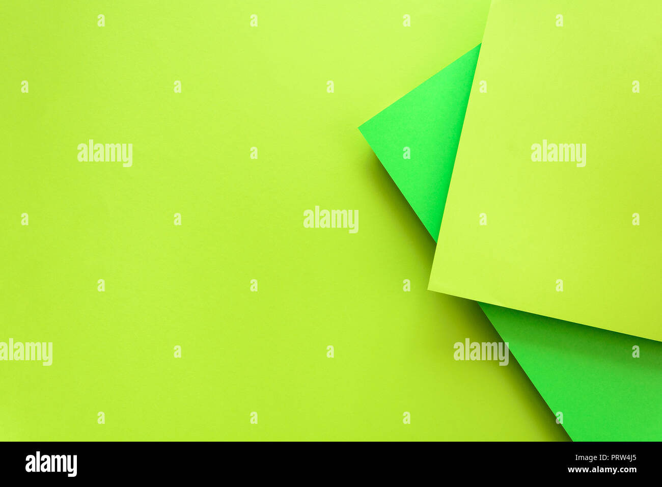 Green and lime pastel color papered background. Volume geometric flat lay. Top view. Copy space Stock Photo