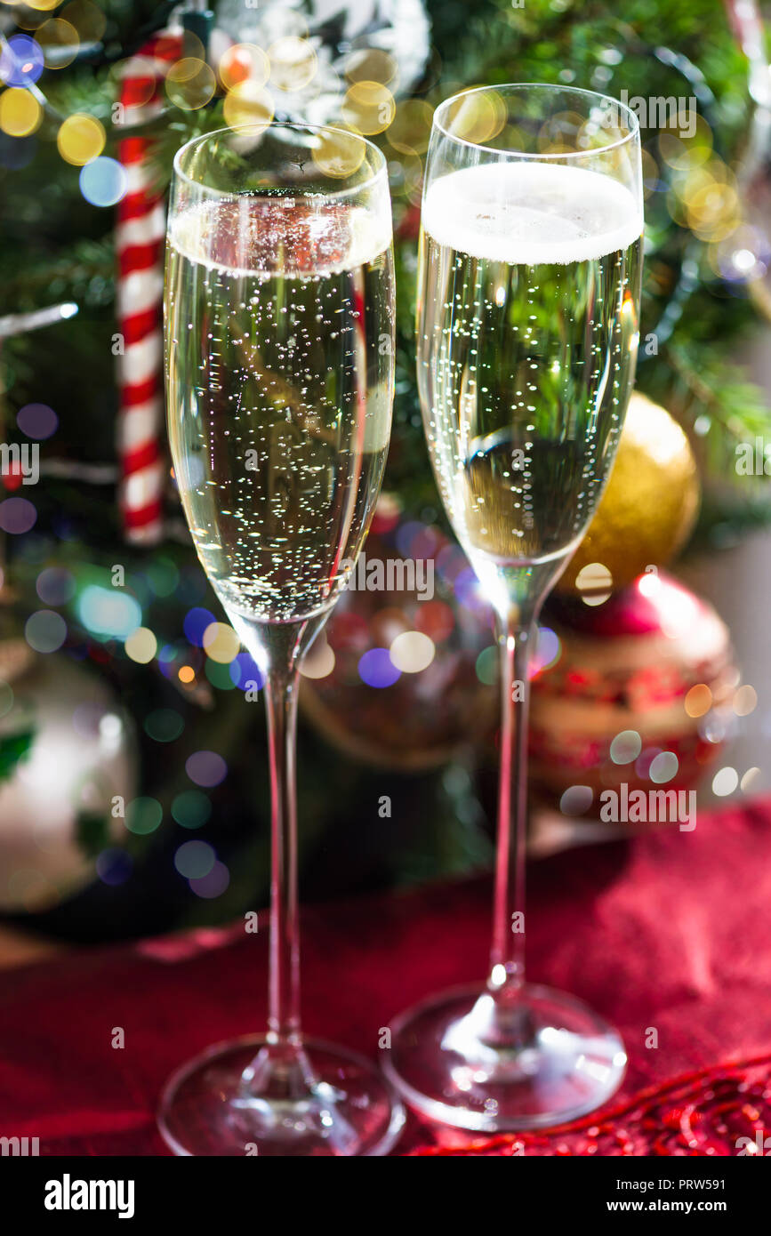 Two Champagne Flutes on Christmas Background with Xmas Tree Stock Photo -  Alamy