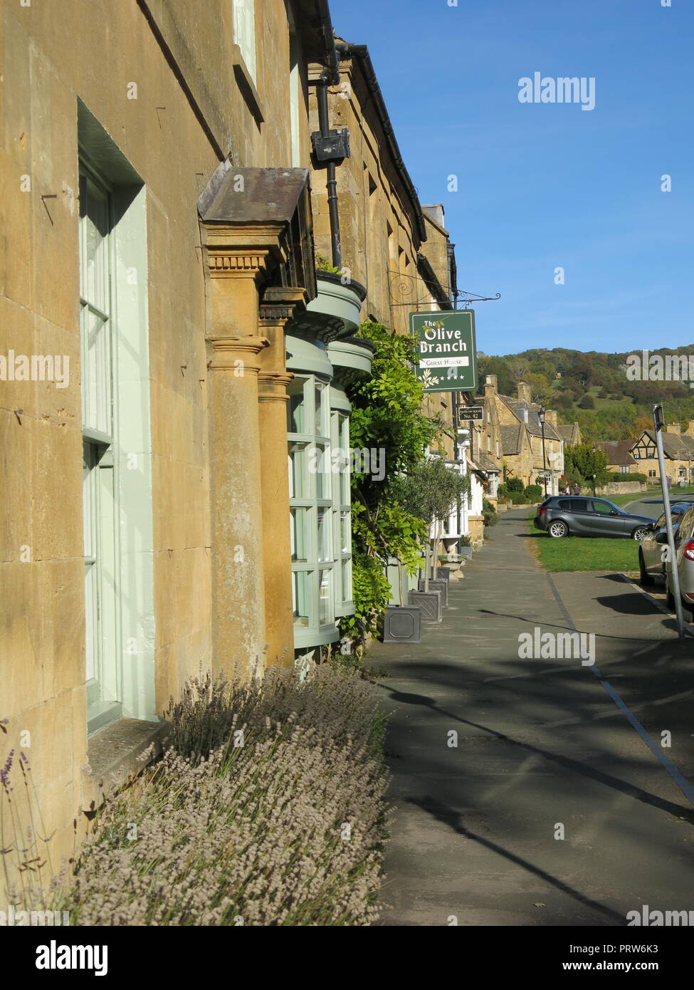 View of honey-coloured Cotswold stone in buildings along the High Street in the picturesque village of Broadway, Worcestershire, England. Stock Photo