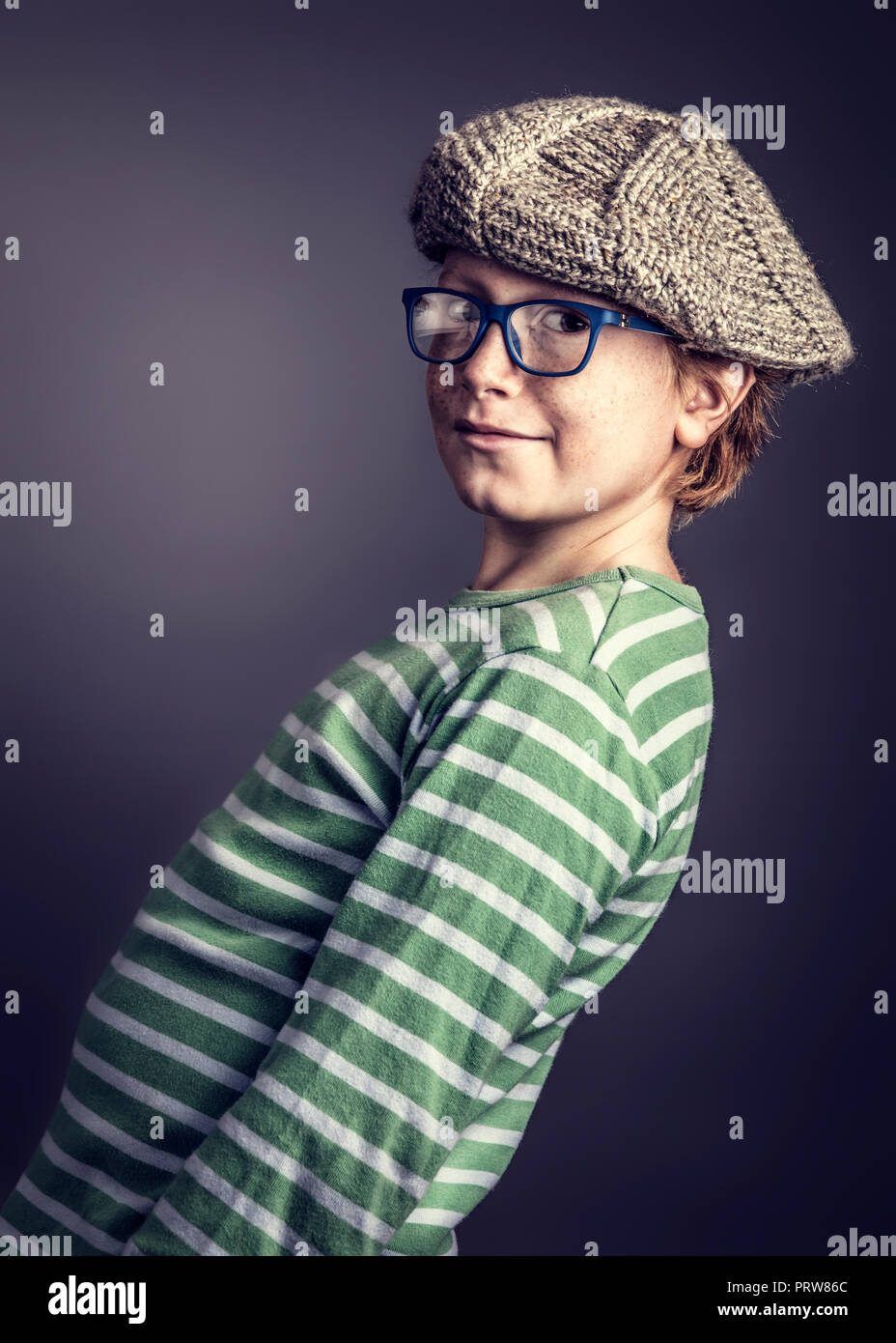 young boy with glasses and cap studio portrait Stock Photo