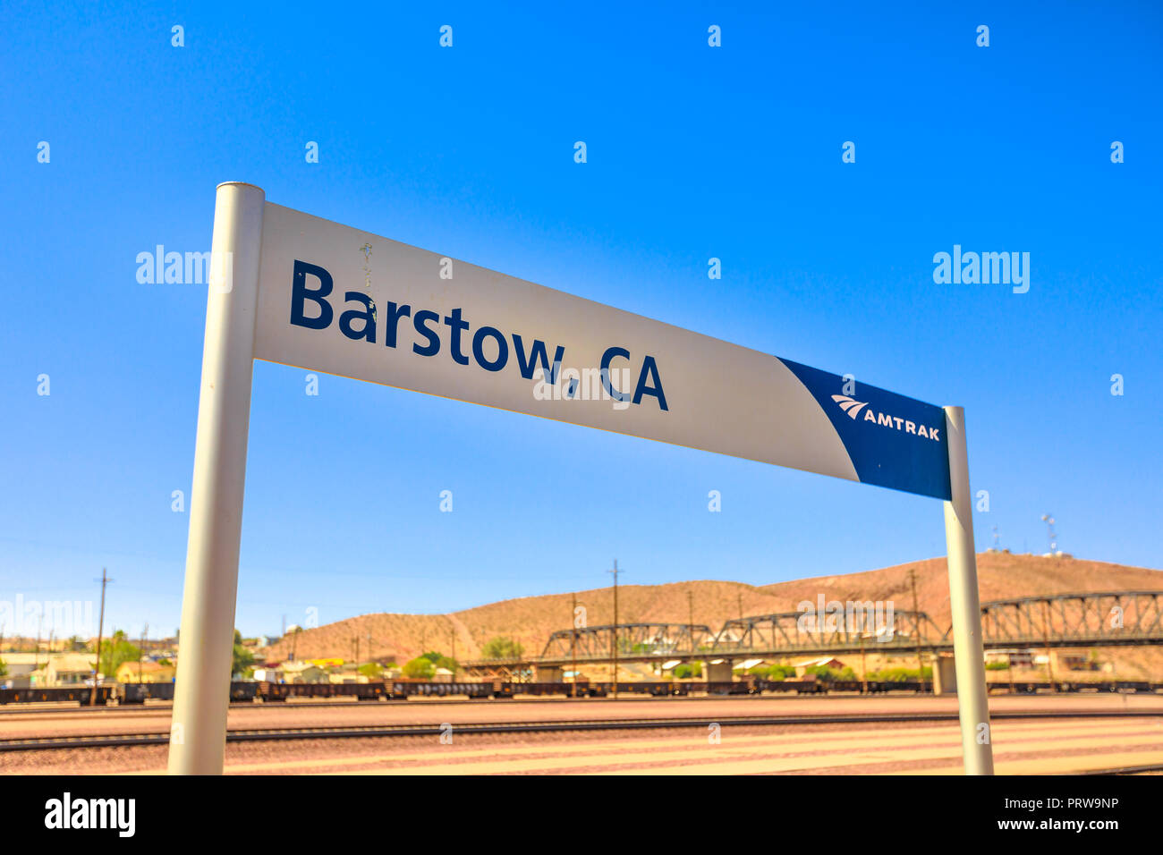 Barstow, California, USA - August 15, 2018: Amtrak Sign at Barstow train station on blue sky. Train Station Platform with Shelter in North First Avenue. Stock Photo