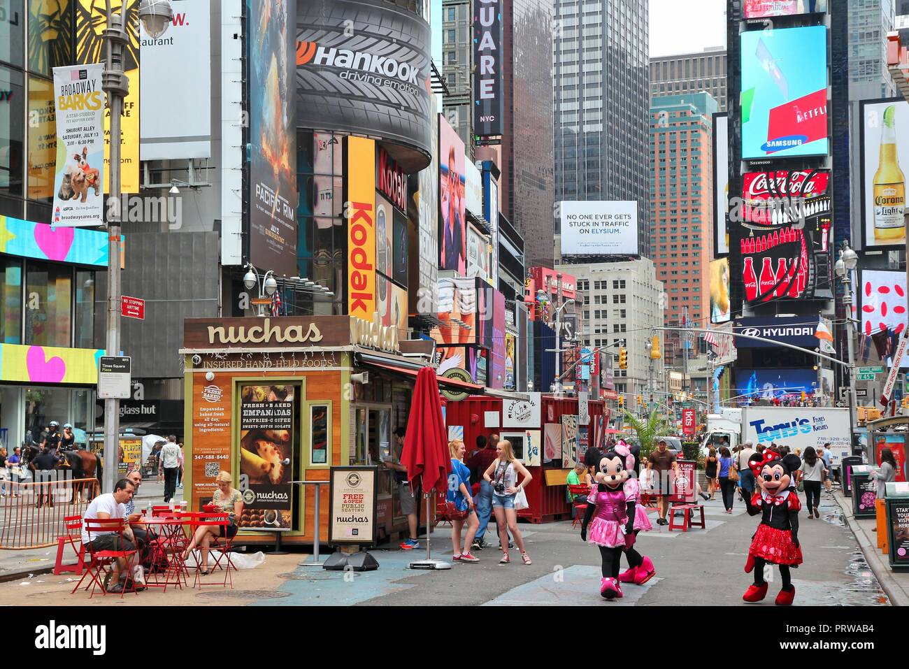 NEW YORK, USA - JULY 3, 2013: People visit Times Square in New York. Times Square is one of most recognized landmarks in the world. More than 300,000  Stock Photo