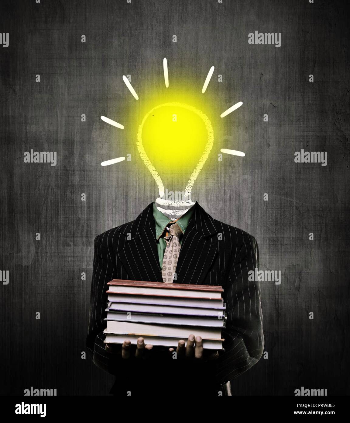 Ideas Bulb Igniting And Holding Books And Wearing Suit,  While Standing Before A Chalkboard, Stock Photo
