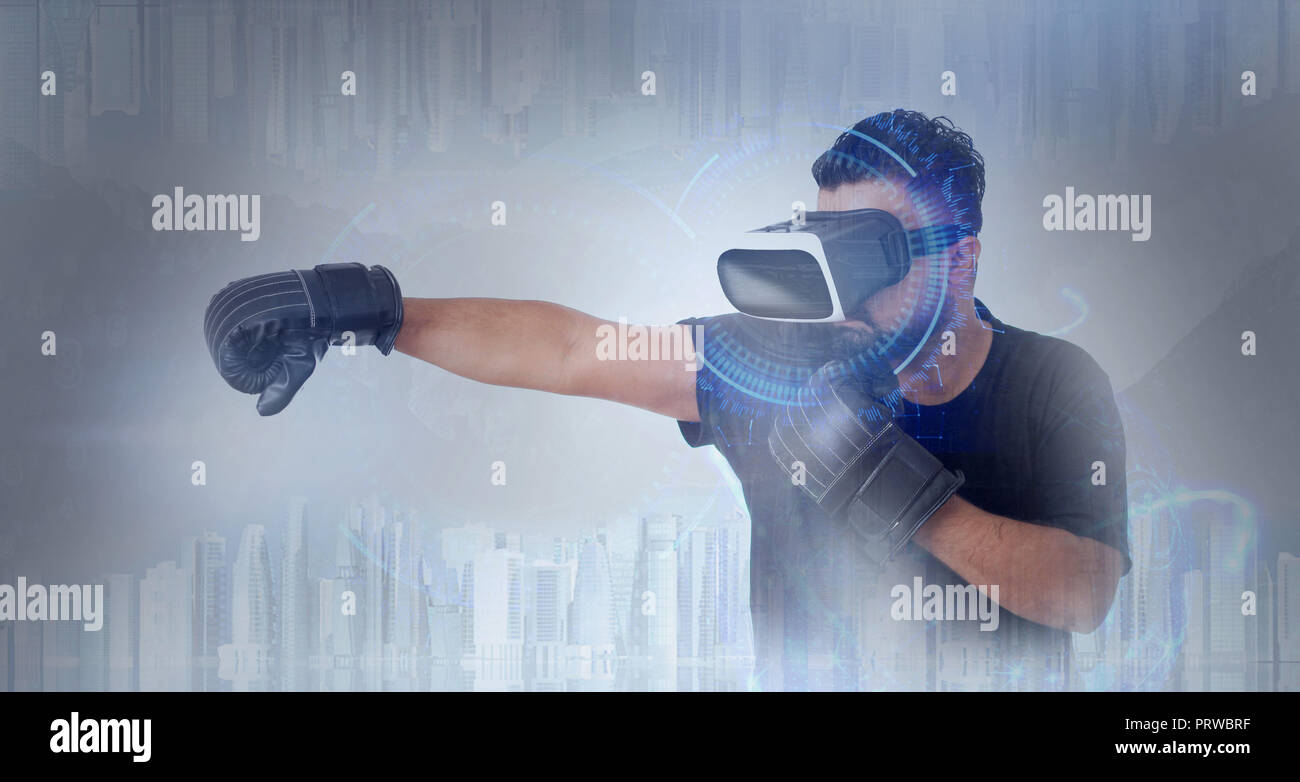 Young Guy in black t shirt looking through VR (Virtual Reality) glasses - Boxing in metaverse Stock Photo