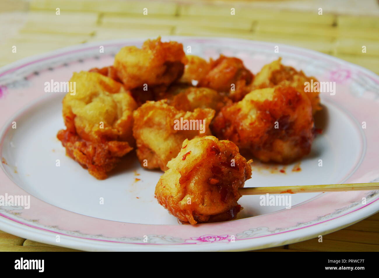 deep fried fish ball dressing chili sauce and wooden stick Stock Photo Alamy