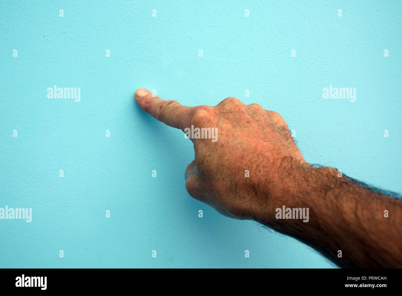 Mans hand pushing an imaginary button Stock Photo