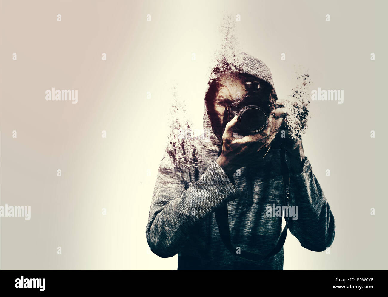 Abstract self portrait of a photographer holding a DSLR camera shattered into pieces. isolated Stock Photo