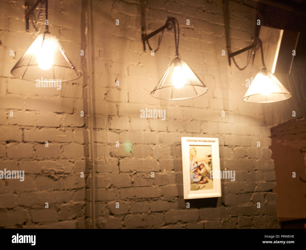 Vintage lighting lamp hang in front of cement brick wall at loft. Stock Photo