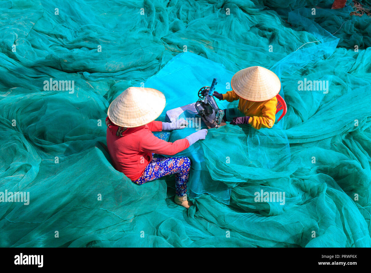 https://c8.alamy.com/comp/PRWF6X/two-women-are-sewing-fishing-nets-in-fishing-village-in-vinh-hy-bay-phan-rang-province-PRWF6X.jpg