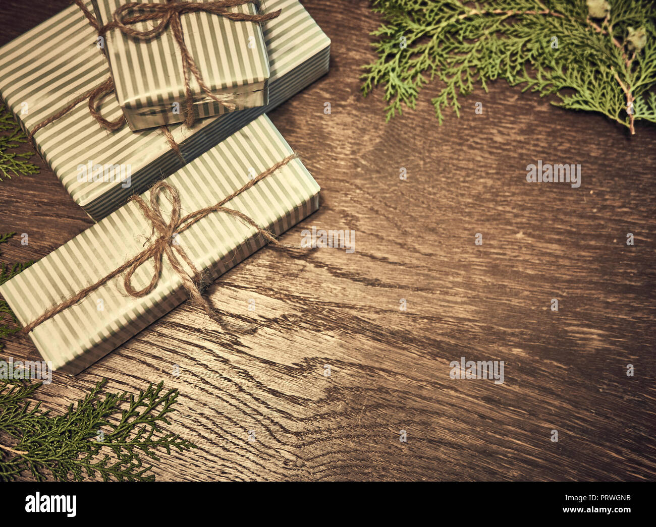 Gift boxes with fir branches on wood background. minimal Christmas ...